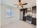 Bright eat-in kitchen with stainless appliances and updated cabinets at 4423 W Tennessee Ave, Denver, CO 80219