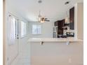 Open kitchen area featuring a breakfast bar with pendant lighting at 4423 W Tennessee Ave, Denver, CO 80219