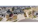 Neighborhood view featuring a well-maintained lawn, sidewalk, and cul-de-sac at 12659 Stone Creek Ct, Firestone, CO 80504