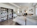 Cozy living room featuring hardwood floors, built-in bookcase, and stylish decor at 26293 E Archer Ave, Aurora, CO 80018