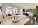 Bright and spacious living room with large windows, plush seating, and an open floor plan at 26293 E Archer Ave, Aurora, CO 80018