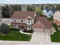 Beautiful two-story home with a well-manicured lawn, mature trees, and an attached two-car garage at 5454 S Everett Ct, Littleton, CO 80123