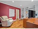 Home office with wood floors, built-in bookshelves, and a large desk for a productive workspace at 5454 S Everett Ct, Littleton, CO 80123