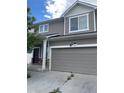 Two-story home with neutral siding, stone accents, and a two-car garage at 5537 Malta St, Denver, CO 80249