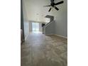 Open living space with tile floors, stairway, and access to the backyard at 5537 Malta St, Denver, CO 80249