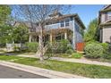 Attractive two-story home with a covered front porch, complemented by mature trees and established landscaping at 3386 Beeler Ct, Denver, CO 80238