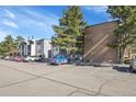 Condo building showcasing parking spaces, balconies, and a well-maintained brick and siding exterior at 1300 Golden Cir # 111, Golden, CO 80401