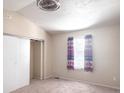 This bedroom has neutral carpet, a ceiling fan, and a window for natural light at 15475 E Louisiana Ave, Aurora, CO 80017