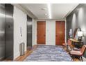 Hallway area featuring wood-like flooring and carpet runner near elevator entrance adjacent to doors to residences at 1901 Wazee St # 419, Denver, CO 80202
