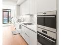 Modern kitchen with sleek white cabinets, stainless steel appliances, and a gas range, ideal for culinary enthusiasts at 1901 Wazee St # 419, Denver, CO 80202