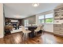 Dining area showcasing hardwood floors, modern decor, and seamless flow into the adjacent kitchen and living spaces at 7746 S Gray St, Littleton, CO 80128