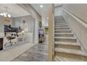 Open-concept entryway showing staircase, wood floors, and a home office with ample natural light, creating an inviting atmosphere at 22583 E Union Cir, Aurora, CO 80015