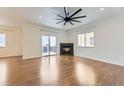 Living room with hardwood floors, fireplace, and access to balcony at 1405 Willow Oak Rd, Castle Rock, CO 80104