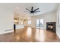 Bright living room with hardwood floors, fireplace, and sliding glass doors leading to a deck at 1405 Willow Oak Rd, Castle Rock, CO 80104