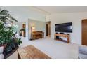 Living room featuring a piano, large TV, and plants at 1817 Buttercup Rd, Elizabeth, CO 80107