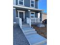 Inviting front porch with white railing, concrete steps, and gravel landscaping at 21996 E 39Th Pl, Aurora, CO 80019