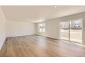 Bright and spacious living room with hardwood flooring and sliding glass doors to the backyard at 21996 E 39Th Pl, Aurora, CO 80019