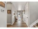 Entryway with a light-colored floor, decorated bench, white door and trim, and access to the staircase at 2576 Villageview Ln, Castle Rock, CO 80104