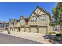 A row of townhomes boasts attached garages and craftsman-style detailing at 1194 Red Lodge Dr # 201, Evergreen, CO 80439