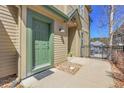 A welcoming green front door entrance, complete with rocky decorative details at 1194 Red Lodge Dr # 201, Evergreen, CO 80439
