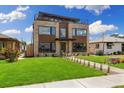 Striking modern residence with a stone and wood exterior, complemented by a green lawn and rooftop terrace at 2010 Irving St, Denver, CO 80211