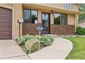 Inviting entryway to home at 8588 with decorative plants and a well-maintained walkway at 8588 E Costilla Ave, Centennial, CO 80112