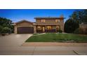 Charming two-story home with a well-manicured lawn and inviting curb appeal at dusk at 8588 E Costilla Ave, Centennial, CO 80112