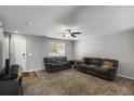 Spacious living room featuring neutral walls, cozy carpet, and a contemporary ceiling fan at 1341 Kingfisher Ave, Brighton, CO 80601