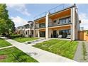 Charming new home exterior with manicured lawn, patio, and modern design elements at 1647 N Osceola St, Denver, CO 80204