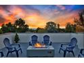 Cozy roof deck with modern fire pit and Adirondack chairs, great for entertaining and enjoying the view at 1374 S Vine St, Denver, CO 80210