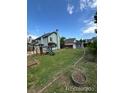 Large, grassy backyard with a playset and a storage shed, offering ample space for outdoor activities and storage at 4362 Denmark Ct, Denver, CO 80239
