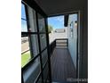 This balcony offers a private outdoor retreat with wood flooring and railings, perfect for relaxation and enjoyment of the view at 4362 Denmark Ct, Denver, CO 80239