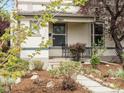Charming home with a welcoming front porch, featuring a cozy seating area, perfect for relaxing outdoors at 3953 Tejon St, Denver, CO 80211