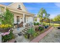 Inviting porch with swing, flower garden, and beautiful landscaping at 8501 W 52Nd Ave, Arvada, CO 80002