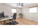 Bright bedroom featuring hardwood floors, natural light, and a ceiling fan at 2963 S Ivan Way, Denver, CO 80227