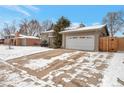 Well-maintained home exterior with a large driveway and attached two-car garage at 2963 S Ivan Way, Denver, CO 80227