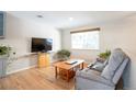 Cozy living room with hardwood floors, a large window, and comfortable seating at 2963 S Ivan Way, Denver, CO 80227