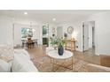 Bright living room featuring hardwood floors, modern furnishings, and an open layout with seamless flow to other spaces at 211 Newport St, Denver, CO 80220
