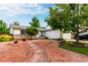 Charming home with a unique xeriscaped front yard, mature trees, and a welcoming two-car garage at 4520 E 112Th Pl, Thornton, CO 80233