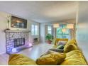 Cozy living room with stone fireplace, modern lighting, and comfortable seating at 17595 E Mansfield Ave # 1331L, Aurora, CO 80013