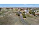 Scenic aerial view showcasing the property's expansive lot, mountain views and the well-maintained landscaping at 8700 Ehler Pkwy, Brighton, CO 80602