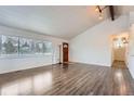 Inviting living room with wood-look floors, large window and bright natural light at 12189 N Boot Hill Dr, Parker, CO 80138