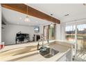 Bright kitchen area featuring a sink overlooking a large island and a cozy living room area at 4899 S Dudley St # 3, Littleton, CO 80123