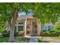 Charming townhome with brick accents, lush landscaping, and inviting front walkway at 13782 E Lehigh Ave # H, Aurora, CO 80014