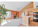 Inviting living room with fireplace, fan, open to kitchen and featuring large windows at 13782 E Lehigh Ave # H, Aurora, CO 80014