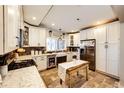 Bright kitchen featuring white cabinets, stainless steel appliances, and stylish backsplash at 1042 Buttercup Rd, Elizabeth, CO 80107