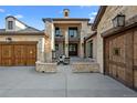 Impressive front entry with an open-air courtyard, stone columns and a cozy fireplace at 7912 Raphael Ln, Littleton, CO 80125