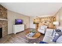 Open concept living area connects to the kitchen, with stone fireplace, and built-in shelving in the dining area at 8225 Fairmount Dr # 106, Denver, CO 80247