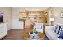 Spacious living area with combined living, dining, and kitchen, creating an open and inviting atmosphere at 8225 Fairmount Dr # 106, Denver, CO 80247
