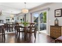 Elegant dining room with a stylish light fixture and sliding glass doors that lead to the outside deck at 4976 S Nelson St # A, Littleton, CO 80127